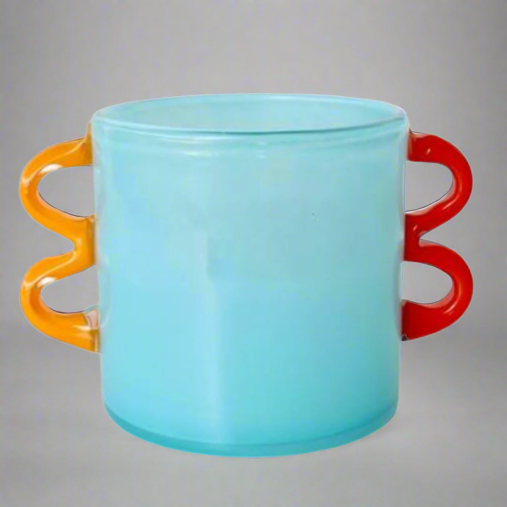 Aqua Blue Glass Vase with Orange Handles
Elevate your space with this stunning handcrafted Aqua Blue Glass Vase, featuring vibrant orange handles. Its unique design adds a pop of color and elegance to any room.Unique Boys.