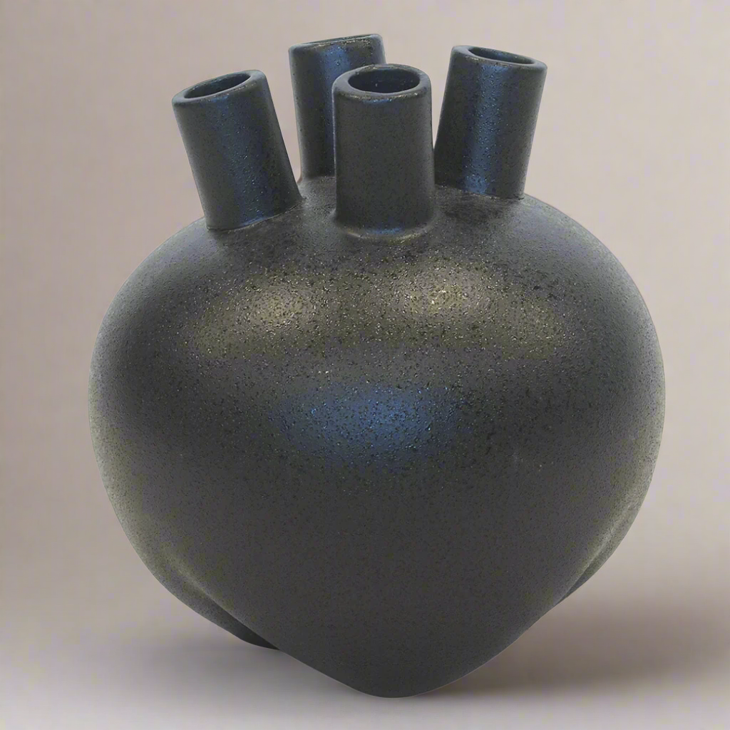 Ceramic Eyo Vase Black (20cm x 22cm)
Elevate your home decor with this stunning ceramic Eyo vase in sleek black. Expertly crafted, its modern design adds sophistication and style to any room.
Product Details:
Size: 20cm (H) x 22cm (D) (7.9 inches x 8.7 inches)
Material: High-quality ceramic
Color: Glossy black
Design: Unique Eyo-inspired shape with smooth finish
Features:
Sleek, modern design complements any decor style
Perfect size for showcasing small flower arrangements or greenery