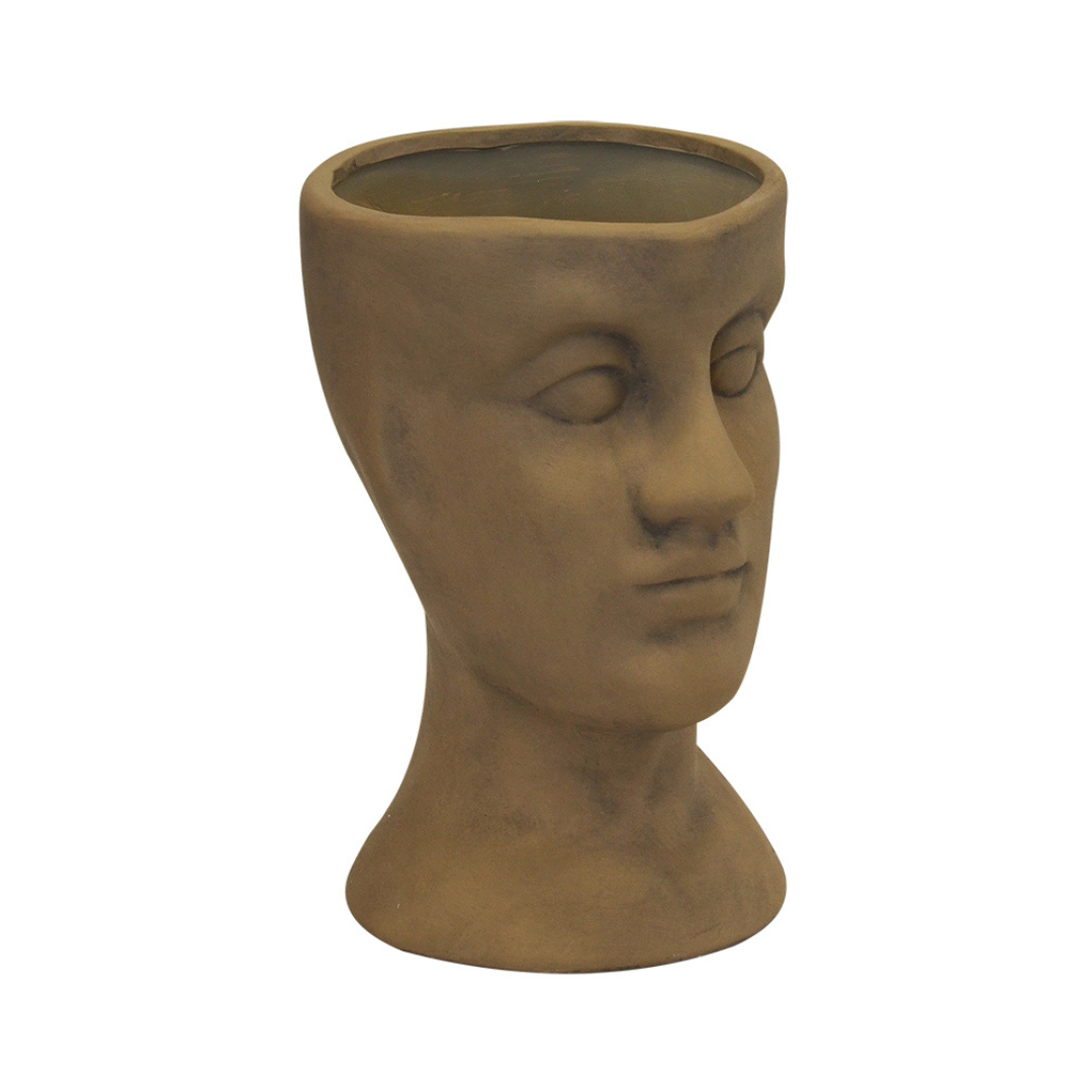 Ceramic head vase desert sand (30cm x 20cm)  Introducing the Ceramic Human Head Vase or Planter, a stunning addition to your home decor collection. This exquisite piece, created by Unique Interiors, features a beautiful desert sand color that complements any color scheme.  Crafted with the utmost attention to detail, this vase/planter measures 30cm in height and 20cm in width, making it the perfect size to hold your favorite plants or flowers. Unique Boys