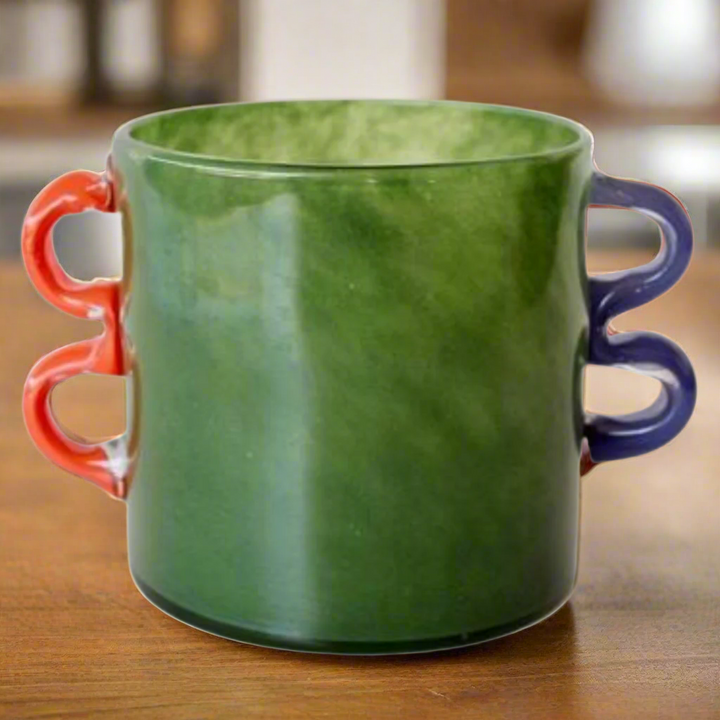 Green Glass Vase with Orange and Blue Handles
Elevate your home decor with this stunning Green Glass Vase, expertly designed and crafted to add a touch of modern elegance to any room. The vibrant orange and blue handles create a unique and eye-catching look that's sure to impress. Unique Boys.