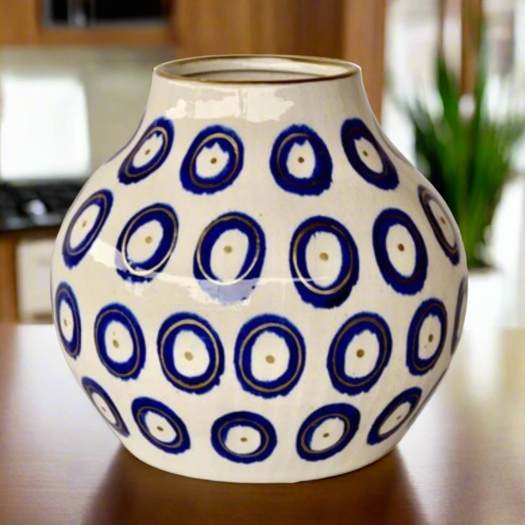 Medium Blue Circle Ceramic Vase Gold Trim 27X26cm
Elevate your home decor with our stunning  Medium Blue Circle Ceramic Vase Gold Trim 27X26cm. Handcrafted with precision and care, this unique vase features a beautiful design that adds a touch of elegance to any room. Its striking is sure to become a focal point in your space, and its size makes it perfect for showcasing your favorite flowers or branches. Unique Boys.