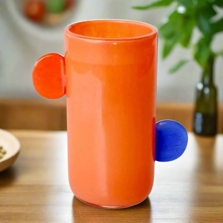 Orange Glass Vase with Blue Accents and Orange Handles
Add a pop of vibrant color to your home decor with this expertly crafted Orange Glass Vase featuring blue accents and stylish orange handles. Measuring 24x20x12cm, this stunning vase is perfect for elevating any room's style. Unique Boys.