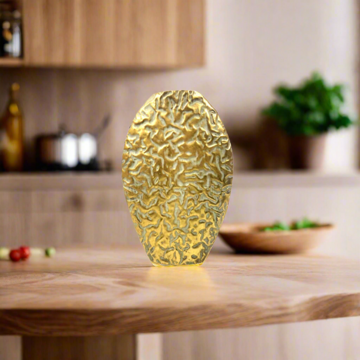 The Sanddance Vase
Add a touch of desert sophistication to your space with The Sanddance Vase. Crafted from metal with an antique gold coating, this vase features a unique texture that evokes the beauty of a sandstorm. Its substantial weight ensures stability, making it perfect for displaying your favorite flowers.