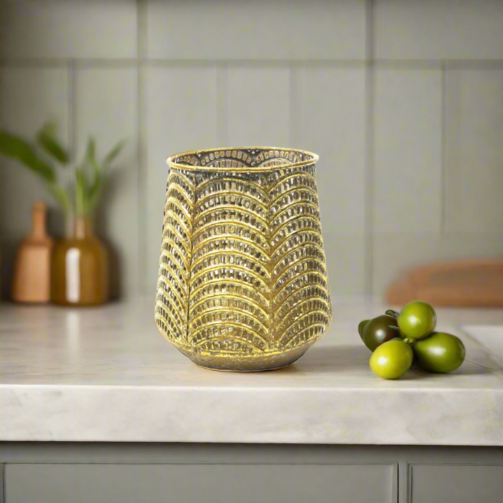 Time To Shine Candleholder/Vase
Boost your home decor with our 13.5cm Time To Shine. Versatile with a glass insert, it works as a candleholder or a flower vase. The pierced metal design in antique gold adds an elegant touch.
