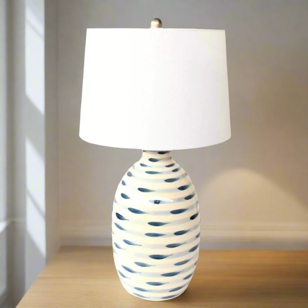 BLUE & WHITE STRIPES LAMP BASE WHITE FINIAL  HARP SHADE 69X38CM.Elevate your home decor with our stunning Blue &amp; White Stripes Lamp Base, a masterpiece of classic design and functionality. This beautifully crafted lamp base features elegant stripes in soothing shades of blue and white, creating a timeless and sophisticated ambiance in any room.
The blue and white stripes are perfectly complemented by the crisp white finial and harp shade, adding a touch of refinement and elegance to your space.