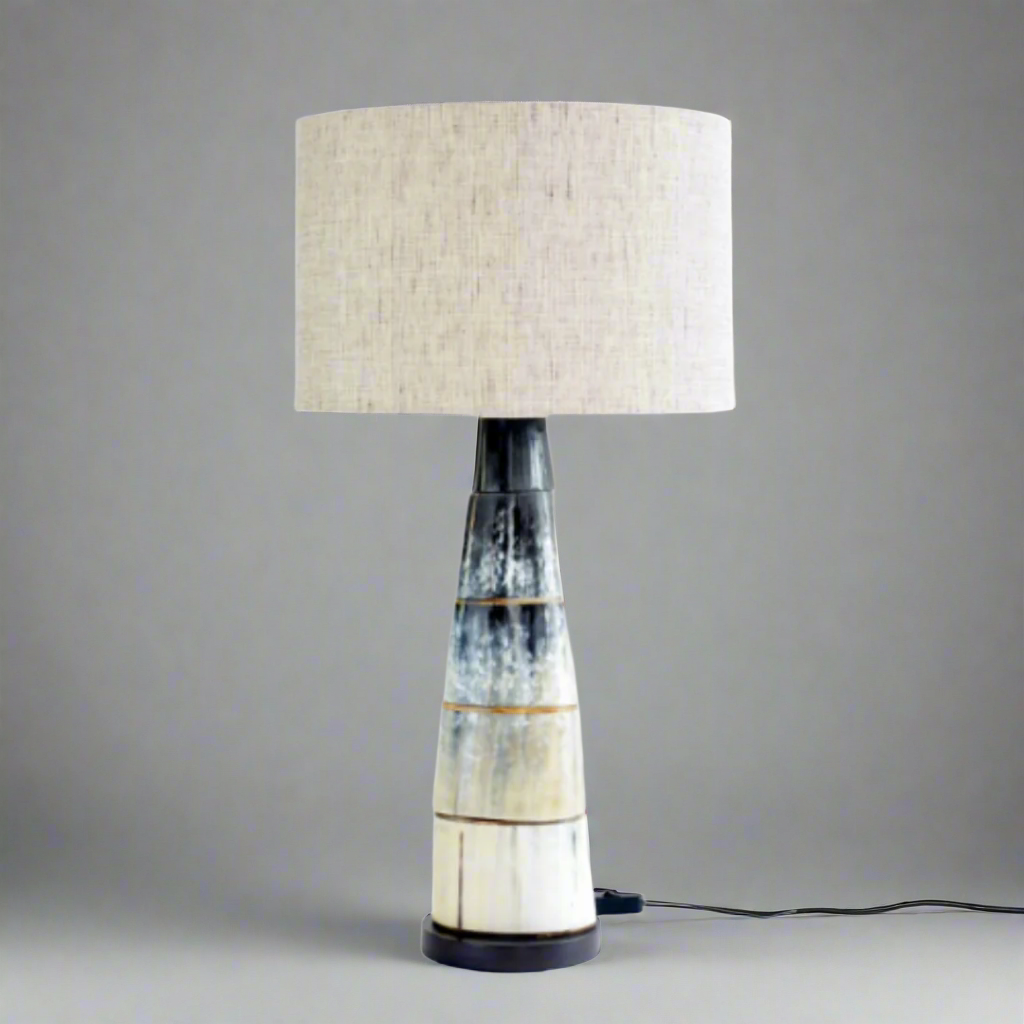Elegant Black Cow Horn Disc Lamp with Linen Shade
Add a touch of rustic sophistication to your home with this stunning lamp. Crafted from natural black cow horns and paired with a soft linen shade, this piece brings warmth and texture to any room.Unique Boys.