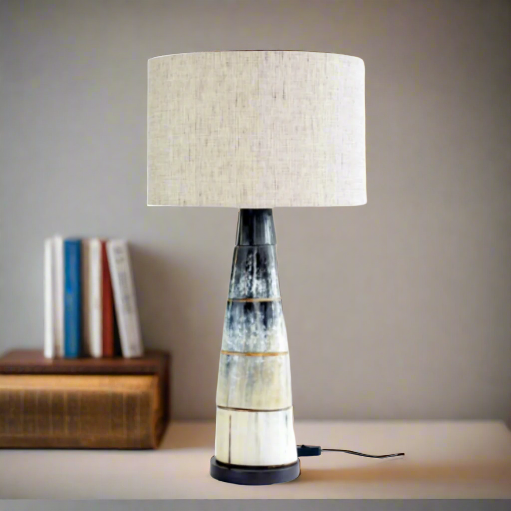 Elegant Black Cow Horn Disc Lamp with Linen Shade
Add a touch of rustic sophistication to your home with this stunning lamp. Crafted from natural black cow horns and paired with a soft linen shade, this piece brings warmth and texture to any room.Unique Boys.