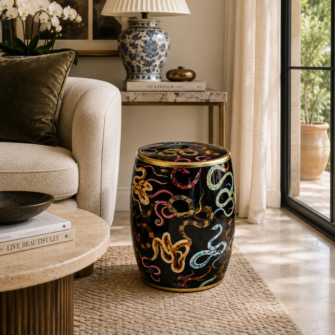 Luxury black ceramic garden stool with colourful snakes design and elegant gold trim accents.