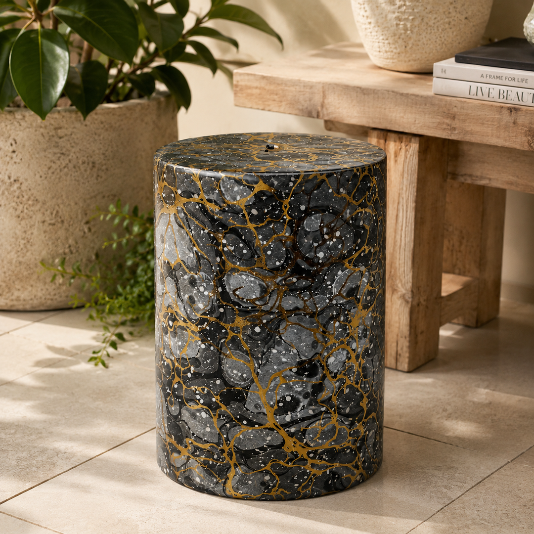 Add luxury to your space with the Black Grey &amp; Gold Garden Stool, featuring a bold artistic marbled design.