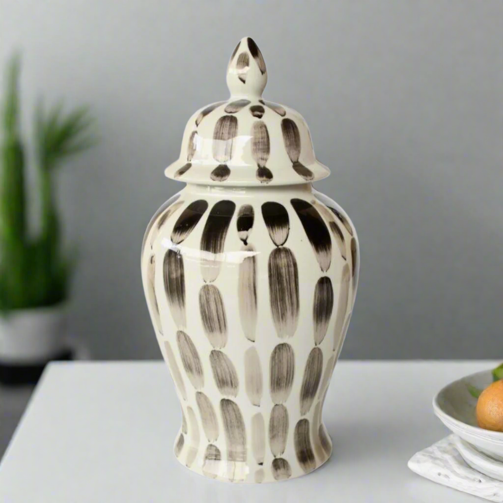 Timeless Elegance: Black Stripe Ginger Jar. Elevate your home decor with the sophisticated Black Stripe Ginger Jar, a beautifully handcrafted piece that combines classic style with modern elegance. Measuring 47x23cm, this stunning jar features a timeless black and white stripe design that adds refinement and visual appeal to any room. Its glossy finish enhances the overall look, making it a beautiful addition to your space. Unique Boys.
