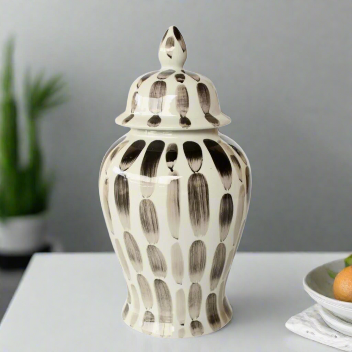 Timeless Elegance: Black Stripe Ginger Jar. Elevate your home decor with the sophisticated Black Stripe Ginger Jar, a beautifully handcrafted piece that combines classic style with modern elegance. Measuring 47x23cm, this stunning jar features a timeless black and white stripe design that adds refinement and visual appeal to any room. Its glossy finish enhances the overall look, making it a beautiful addition to your space. Unique Boys.