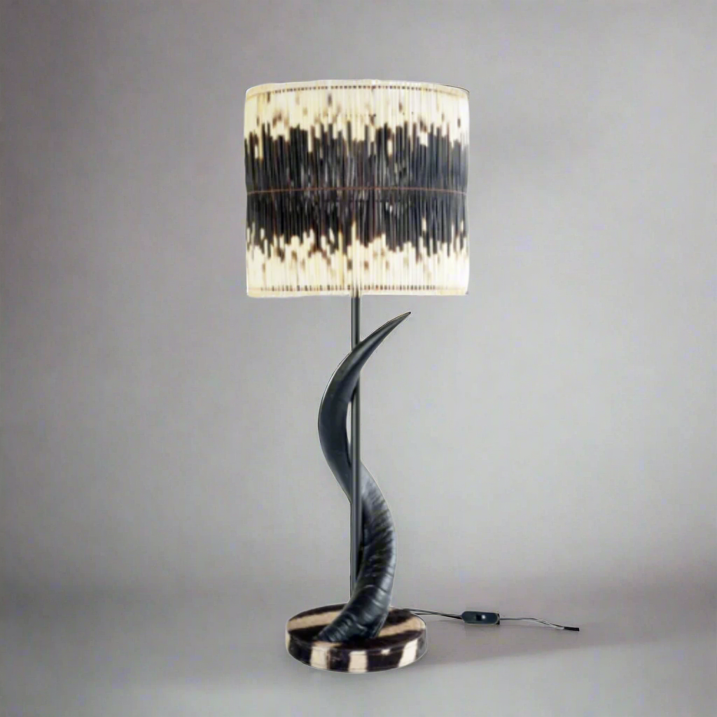 Unique Black Kudu Horn Lamp
Elevate your home decor with the majestic beauty of African wildlife. This exquisite lamp features intricately crafted black kudu horns set atop a striking zebra base, paired with two rows of natural quill shades that add warmth and texture to any room. Unique Boys.
