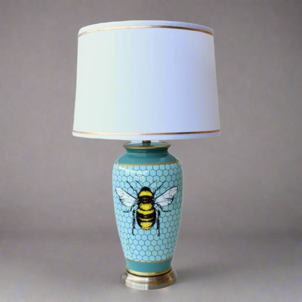Unique Boys Blue Honey Comb Bee Lamp Base
Add a touch of nature-inspired elegance to your space with our stunning Blue Honey Comb Bee Lamp Base from Unique Boys. This beautifully crafted lamp features a blue honeycomb design adorned with bees, paired with a crisp white shade and luxurious gold trim. Measuring 68x40cm, this lamp base is the perfect size to make a statement in any room. Unique Boys Interiors.