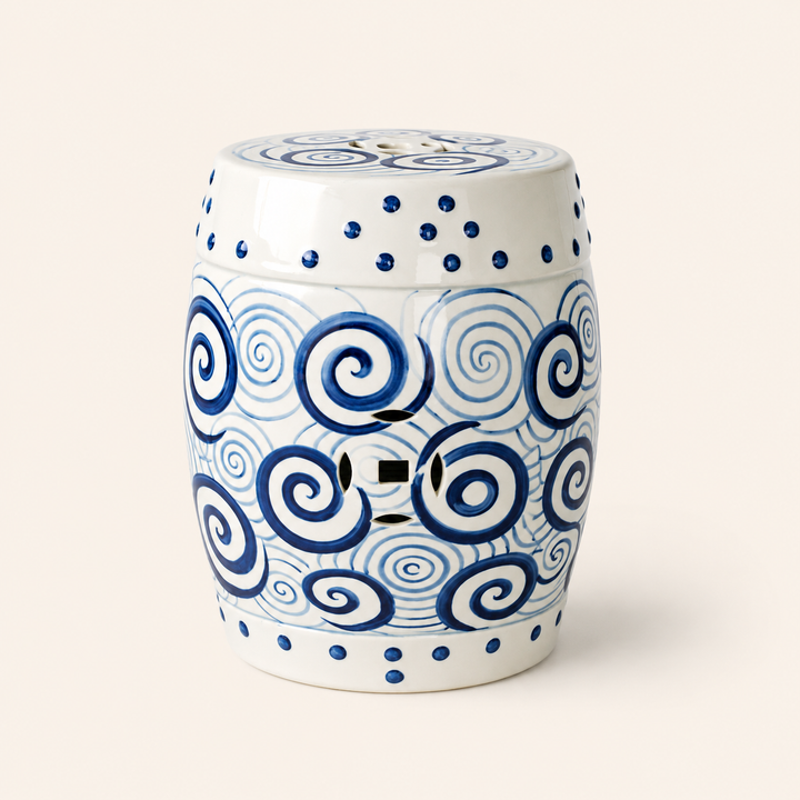 Elegant blue and white ceramic garden stool with swirling circles for timeless home décor.