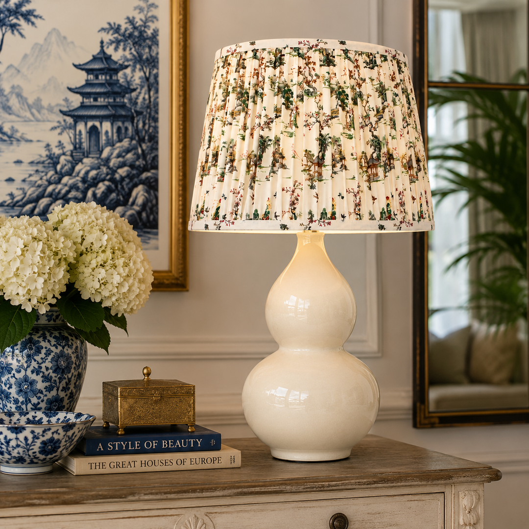 Elegant Cream Ceramic Lamp with a charming toile shade, perfect for adding classic style and warmth to your home.