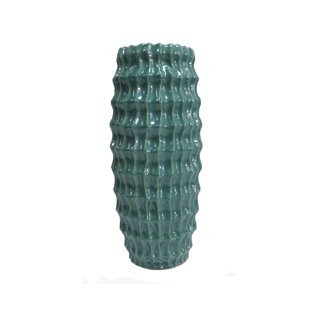 Elevate Your Space with the Stunning Diaspora Vase
Add a touch of elegance and sophistication to any room with the beautiful Diaspora vase. Crafted from high-quality ceramic, this stunning vase boasts a unique, intense teal color with a melted glass look that's sure to impress.
Expertly Crafted
The Diaspora vase is expertly glazed to ensure a long-lasting, beautiful finish. Its perfect size (14cm D x 32cmH) makes it ideal for showcasing long-stemmed greenery, branches, or flowers, adding a touch of natural 