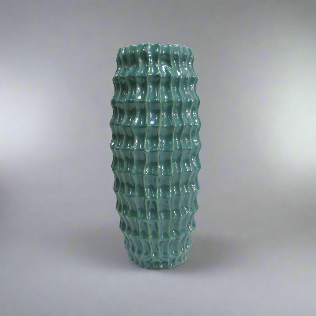 Elevate Your Space with the Stunning Diaspora Vase
Add a touch of elegance and sophistication to any room with the beautiful Diaspora vase. Crafted from high-quality ceramic, this stunning vase boasts a unique, intense teal color with a melted glass look that's sure to impress.
Expertly Crafted
The Diaspora vase is expertly glazed to ensure a long-lasting, beautiful finish. Its perfect size (14cm D x 32cmH) makes it ideal for showcasing long-stemmed greenery, branches, or flowers, adding a touch of natural 