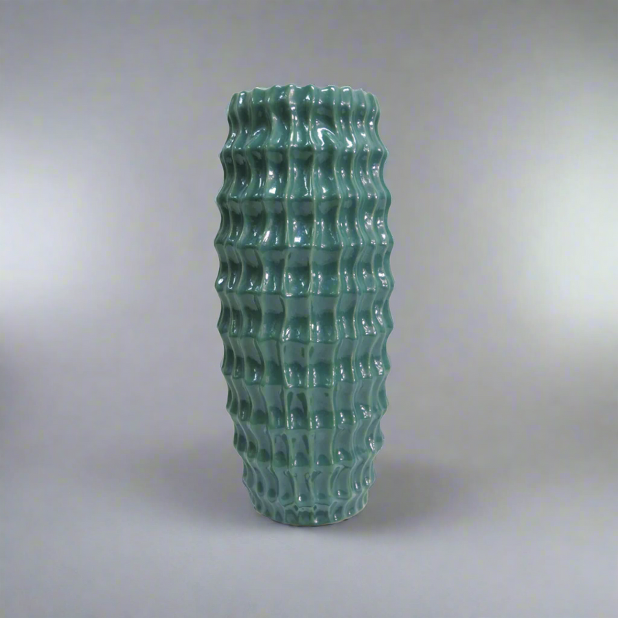 Elevate Your Space with the Stunning Diaspora Vase
Add a touch of elegance and sophistication to any room with the beautiful Diaspora vase. Crafted from high-quality ceramic, this stunning vase boasts a unique, intense teal color with a melted glass look that's sure to impress.
Expertly Crafted
The Diaspora vase is expertly glazed to ensure a long-lasting, beautiful finish. Its perfect size (14cm D x 32cmH) makes it ideal for showcasing long-stemmed greenery, branches, or flowers, adding a touch of natural 