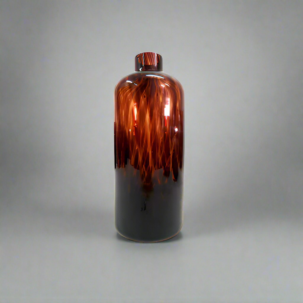 Introducing the Exquisite Oro Vase from Unique Boys
Elevate your home decor with this stunning, one-of-a-kind Oro Vase, expertly crafted with a mesmerizing tortoise shell design glass. Its unique jar/bottle shape adds an air of sophistication, making it a perfect conversation starter for any living space.