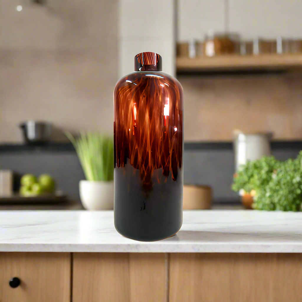 Introducing the Exquisite Oro Vase from Unique Boys
Elevate your home decor with this stunning, one-of-a-kind Oro Vase, expertly crafted with a mesmerizing tortoise shell design glass. Its unique jar/bottle shape adds an air of sophistication, making it a perfect conversation starter for any living space.