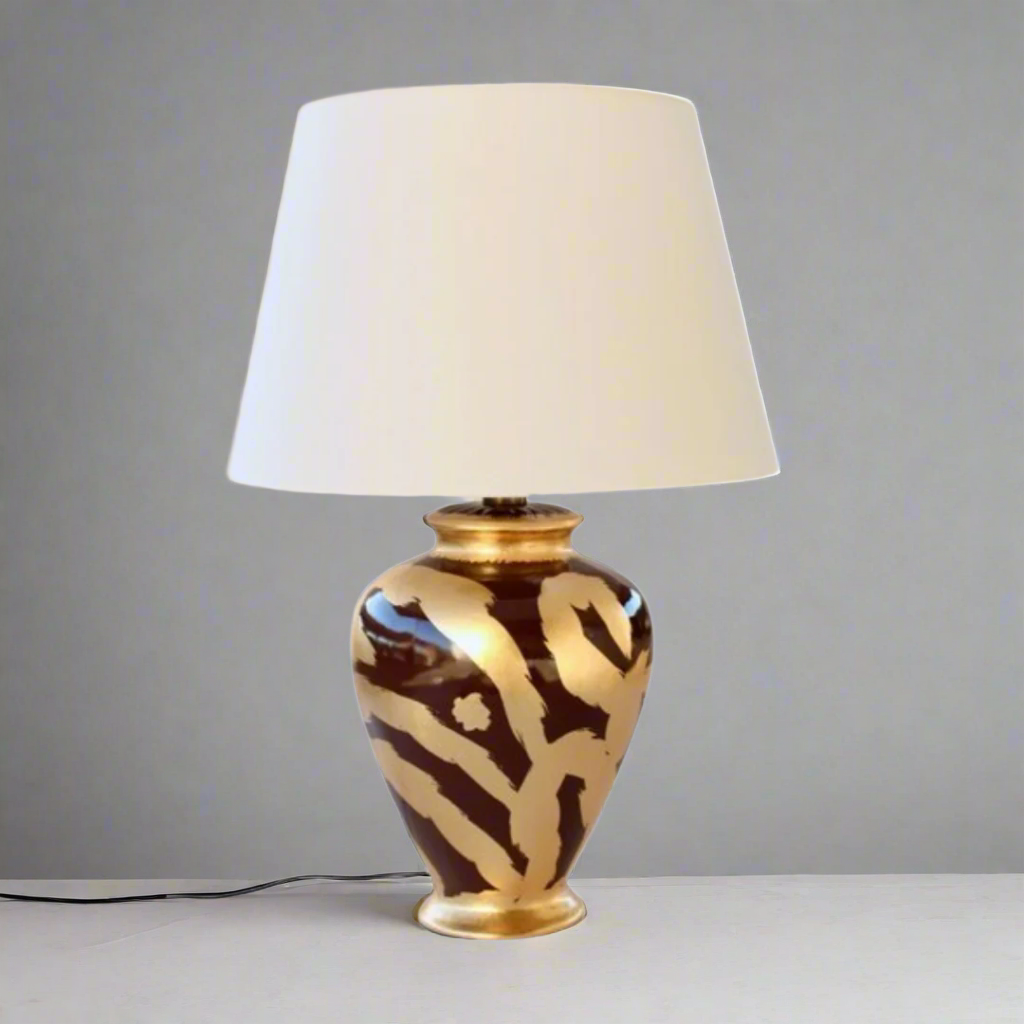 Gold &amp; Brown Swirl &nbsp;Lamp Base With Shade 70X46cm
Add a touch of warmth and sophistication to your space with our stunning Gold &amp; Brown Swirl Lamp Base With Shade. This unique lamp features a beautifully swirled gold and brown design, creating a cozy and inviting ambiance perfect for relaxing or entertaining. Measuring 70cm in height and 46cm in width, this lamp is perfectly sized for living rooms, bedrooms, or offices. Unique Boys