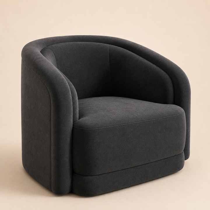 A modern barrel-style armchair upholstered in dark charcoal gray fabric, shown from a three-quarter angle against a solid beige background.
