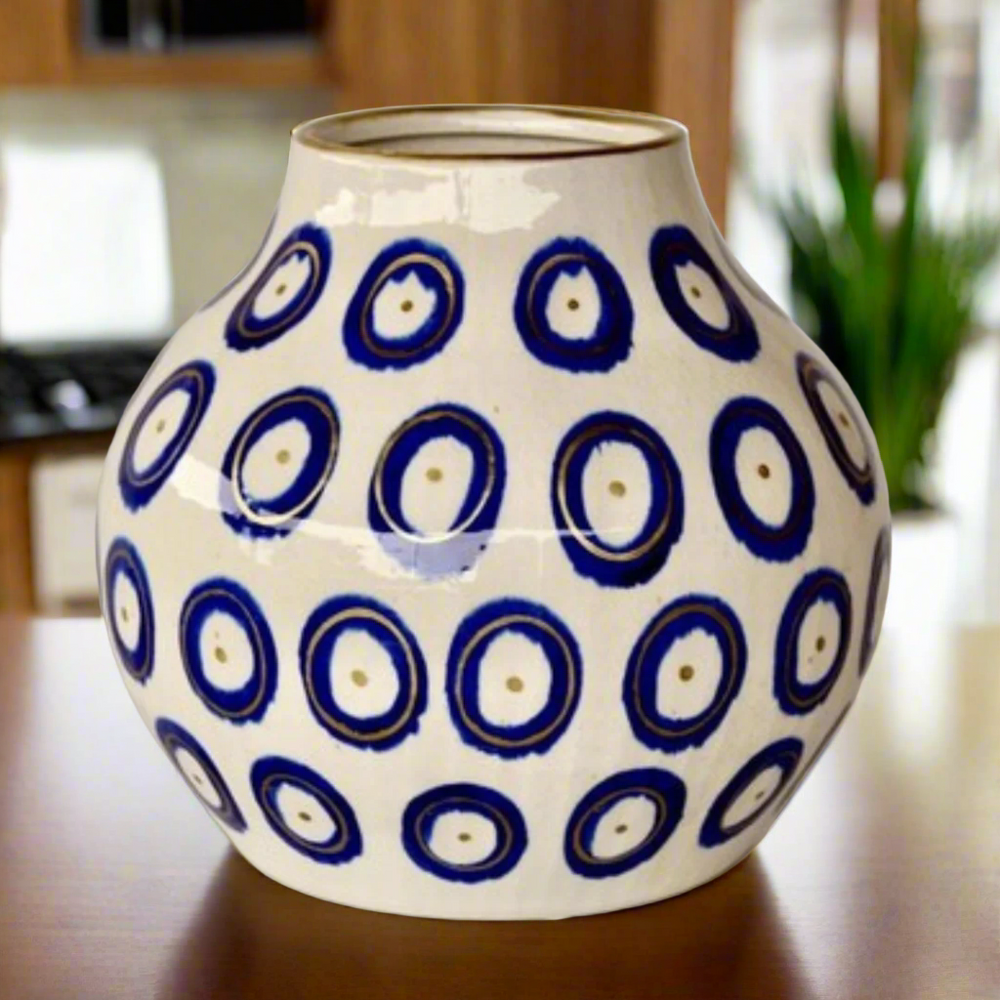Medium Blue Circle Ceramic Vase Gold Trim 27X26cm
Elevate your home decor with our stunning &nbsp;Medium Blue Circle Ceramic Vase Gold Trim 27X26cm. Handcrafted with precision and care, this unique vase features a beautiful design that adds a touch of elegance to any room. Its striking is sure to become a focal point in your space, and its size makes it perfect for showcasing your favorite flowers or branches. Unique Boys.