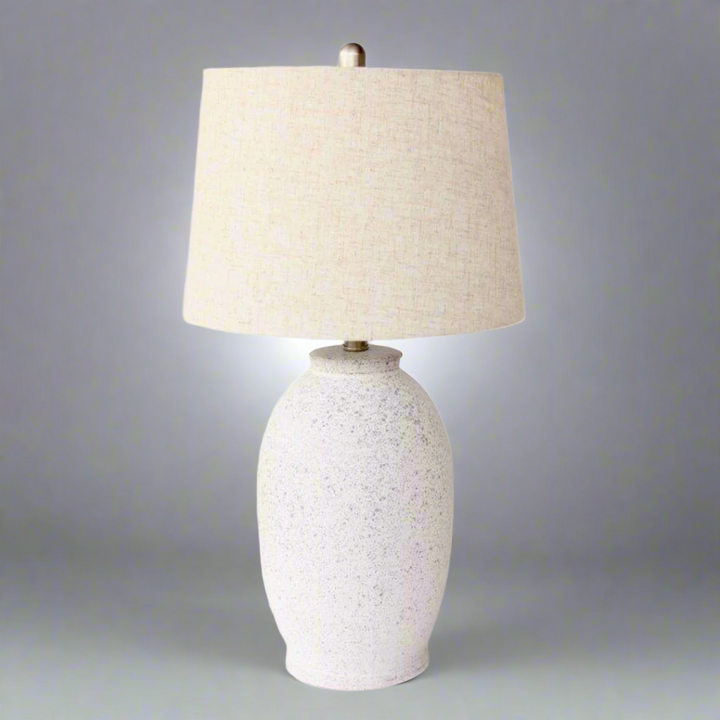 Off White Speckled Lamp Base Beige Linen Finial & lamp; Harp Shade 63X35cm. Warm up your space with the charming Off White Speckled Lamp Base. Its unique speckled design adds texture and visual interest, while the neutral beige linen finial and elegant harp shade bring a touch of sophistication to any room.Unique Boys.
