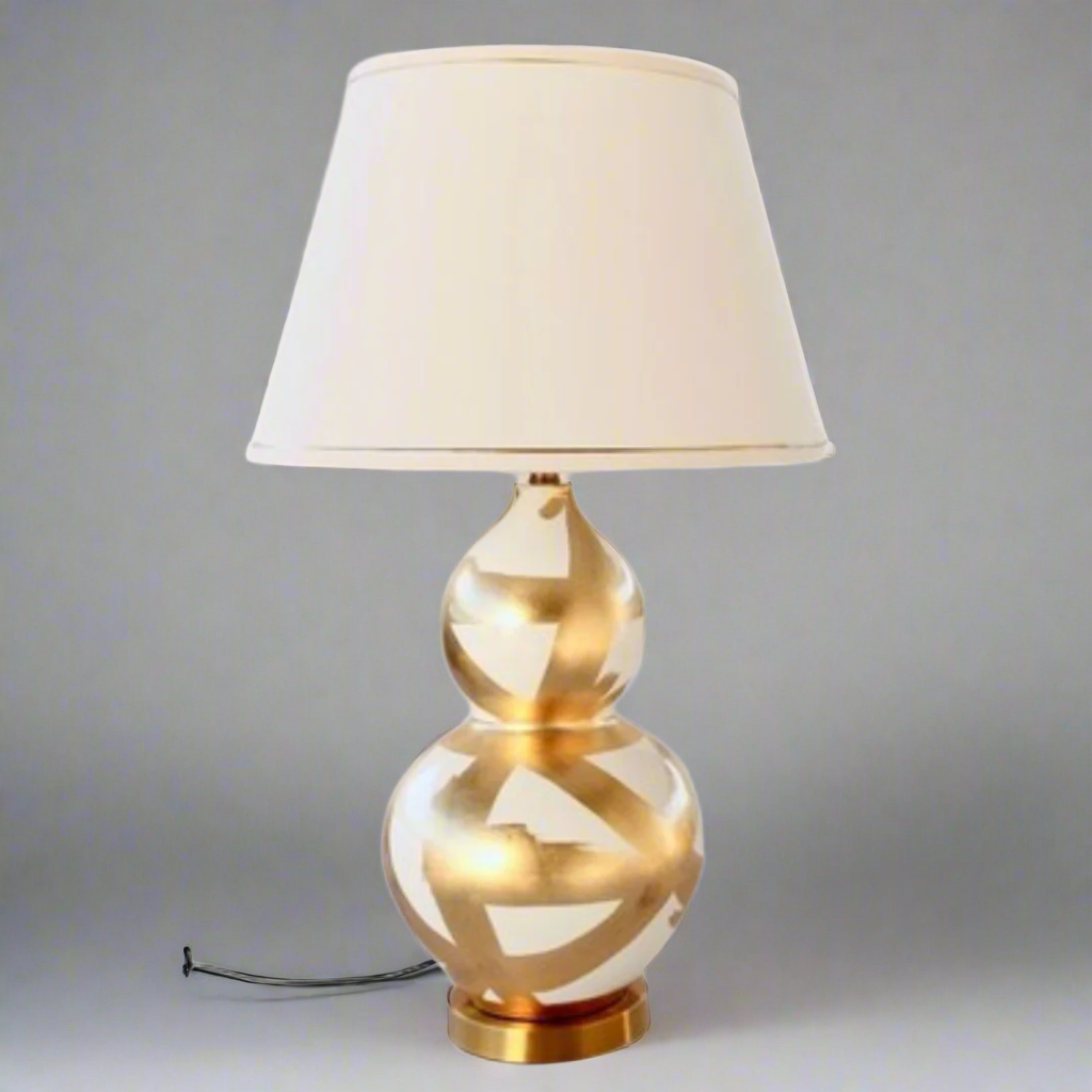 Off White &amp; Gold Painted Lamp Base With Gold Trim Shade 75X45cm
Elevate your home decor with our stunning Off White &amp; Gold Painted Lamp Base With Gold Trim Shade. This unique lamp features a beautifully painted off-white base paired with a luxurious gold trim shade, creating a sophisticated and elegant ambiance perfect for relaxing or entertaining. Measuring 75cm in height and 45cm in width, this lamp is perfectly sized for living rooms, bedrooms, or offices. Unique Boys.