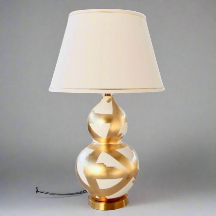 Off White &amp; Gold Painted Lamp Base With Gold Trim Shade 75X45cm
Elevate your home decor with our stunning Off White &amp; Gold Painted Lamp Base With Gold Trim Shade. This unique lamp features a beautifully painted off-white base paired with a luxurious gold trim shade, creating a sophisticated and elegant ambiance perfect for relaxing or entertaining. Measuring 75cm in height and 45cm in width, this lamp is perfectly sized for living rooms, bedrooms, or offices. Unique Boys.
