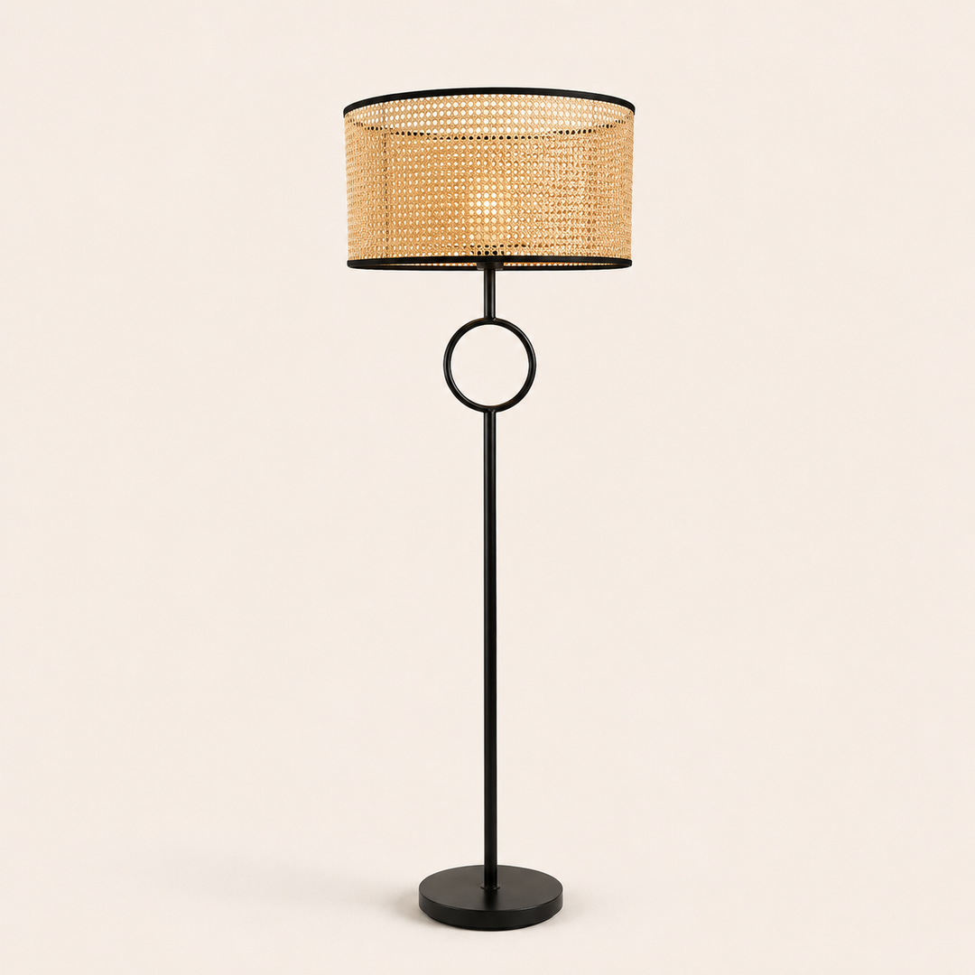 Pasquale Floor Lamp with a natural woven shade and sleek black frame, bringing warmth and elegance to interiors.