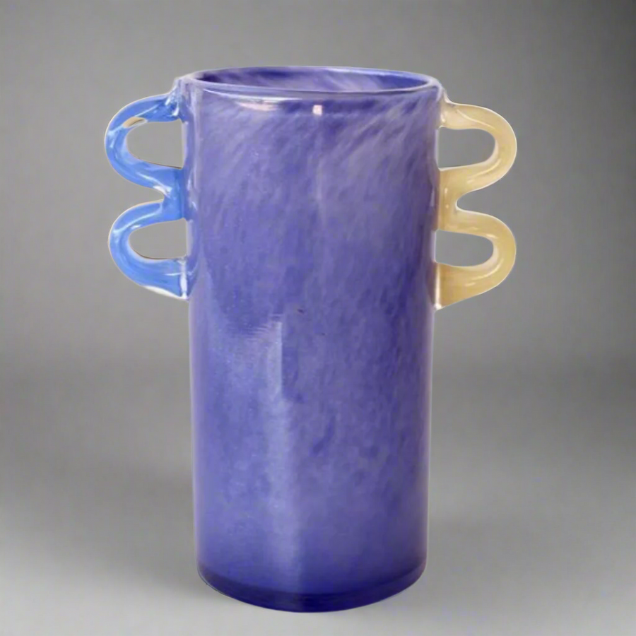 Purple Glass Vase with Blue &amp; Yellow Handles
Elevate your home decor with this stunning Purple Glass Vase, featuring striking blue and yellow handles. Its unique design and high-quality glass construction make it perfect for showcasing floral arrangements or as a standalone decorative piece. Unique Boys.
