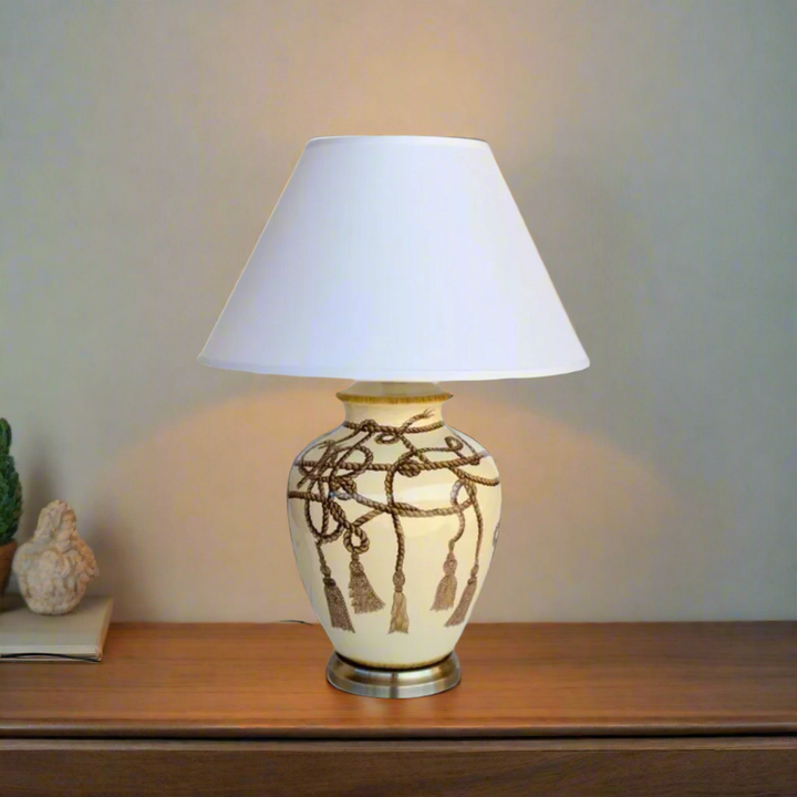 Rope Tassel Lamp with Off White Shade (70x50cm)
Elevate your home decor with this stylish Rope Tassel Lamp featuring an Off White Shade, measuring 70x50cm. The elegant rope tassel detail and soft off-white hue add a modern touch to any room, creating a warm and inviting atmosphere. This lamp is not only functional but also a beautiful piece of art, perfect for illuminating your lounge, bedroom, dining room, or reception area. www.uniqueboys.co.za