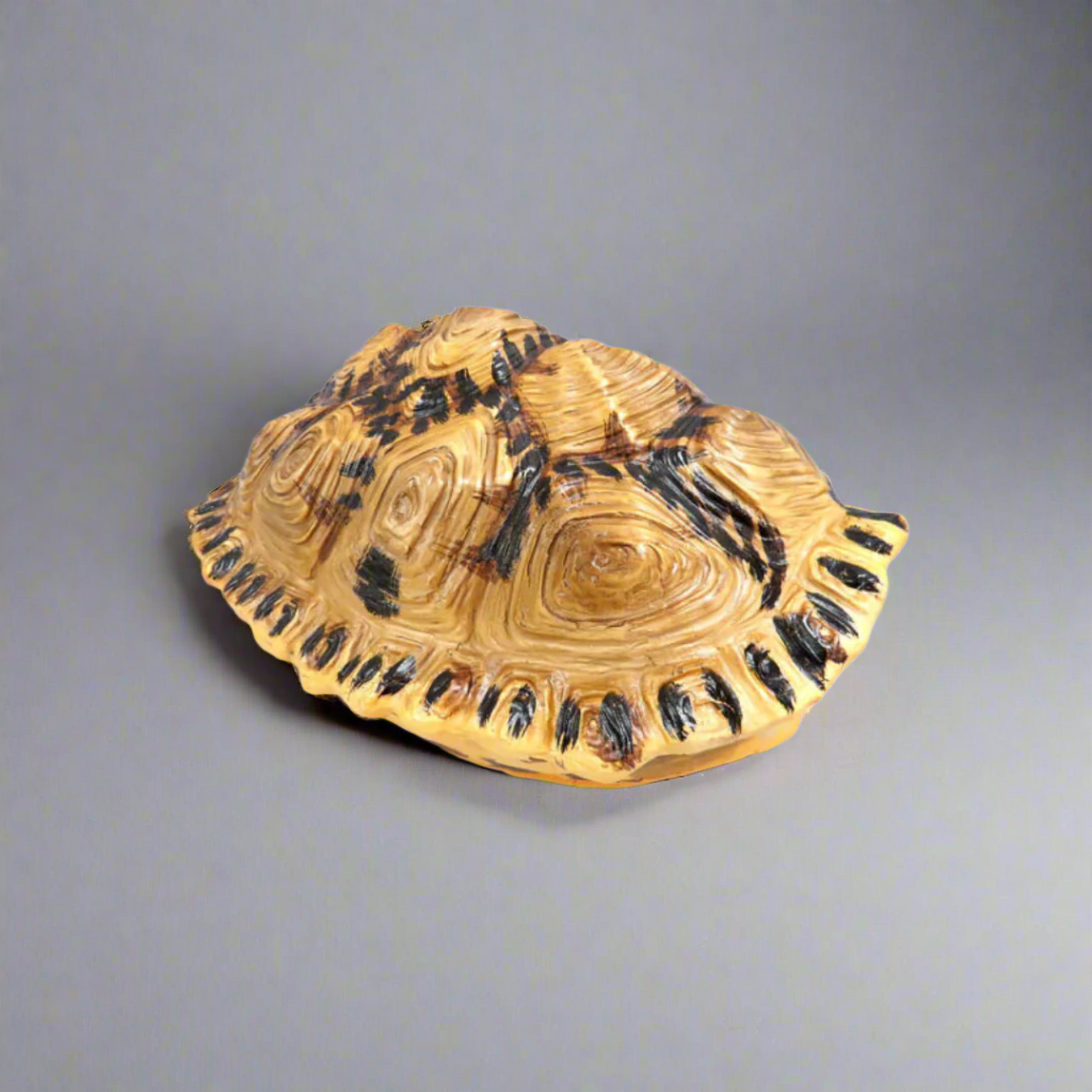 Introducing the Shyman Tortoise
Elegant and Versatile Decor for Your Home
Add a touch of elegance to your space with our beautifully crafted Shyman Tortoise. Measuring 21cm x 14cm x 28cm, this chunky, double-sided decor piece offers versatile display options - hang it up or use it as a stunning table centerpiece.
