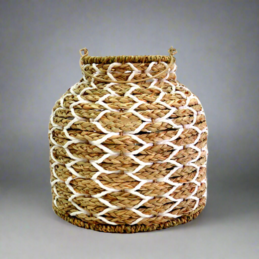 Sunset Strip Lantern
The Sunset Strip Lantern is expertly crafted with handwoven natural material rope, encircling a sturdy metal frame. The soft white accents in the weaving add a touch of elegance to this highly desirable lantern.