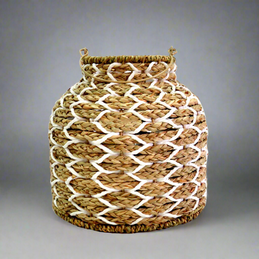 Sunset Strip Lantern
The Sunset Strip Lantern is expertly crafted with handwoven natural material rope, encircling a sturdy metal frame. The soft white accents in the weaving add a touch of elegance to this highly desirable lantern.
