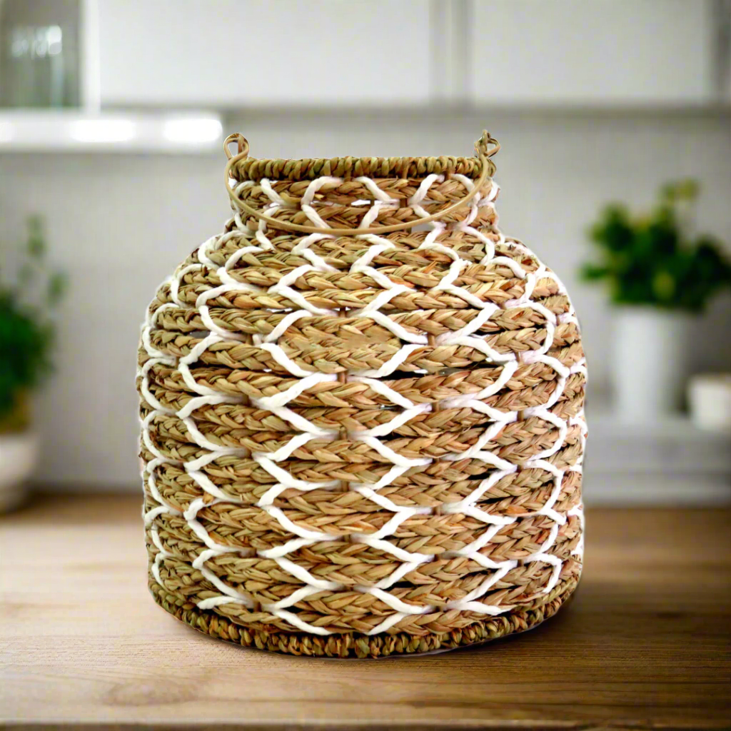 Sunset Strip Lantern
The Sunset Strip Lantern is expertly crafted with handwoven natural material rope, encircling a sturdy metal frame. The soft white accents in the weaving add a touch of elegance to this highly desirable lantern.