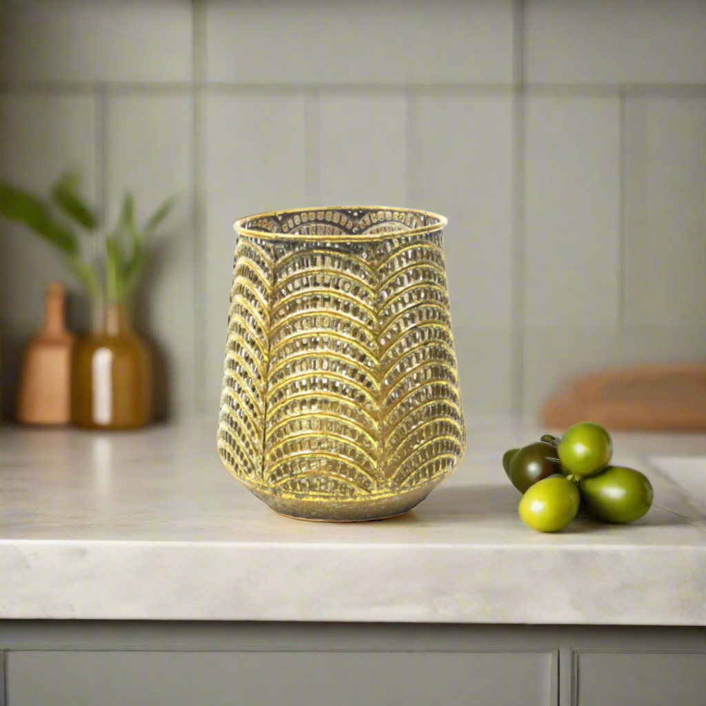 Time To Shine Candleholder/Vase
Boost your home decor with our 13.5cm Time To Shine. Versatile with a glass insert, it works as a candleholder or a flower vase. The pierced metal design in antique gold adds an elegant touch.