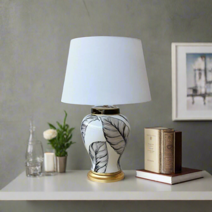 Unique Boys White &amp; Black Leaf Lamp Base
Elevate your space with our stunning White &amp; Black Leaf Lamp Base, expertly handcrafted for elegance and sophistication. The classic leaf design in white and black is paired with a beautiful off-white shade, creating a harmonious balance. Made from high-quality materials, this 65x44cm lamp base is durable and long-lasting. A true statement piece that adds a timeless touch to any room.uniqueboys