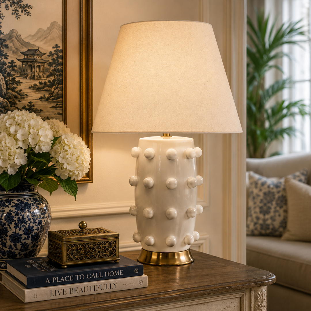 White Ceramic Knob Lamp with brass detail and beige shade, a sophisticated statement for elegant interiors.