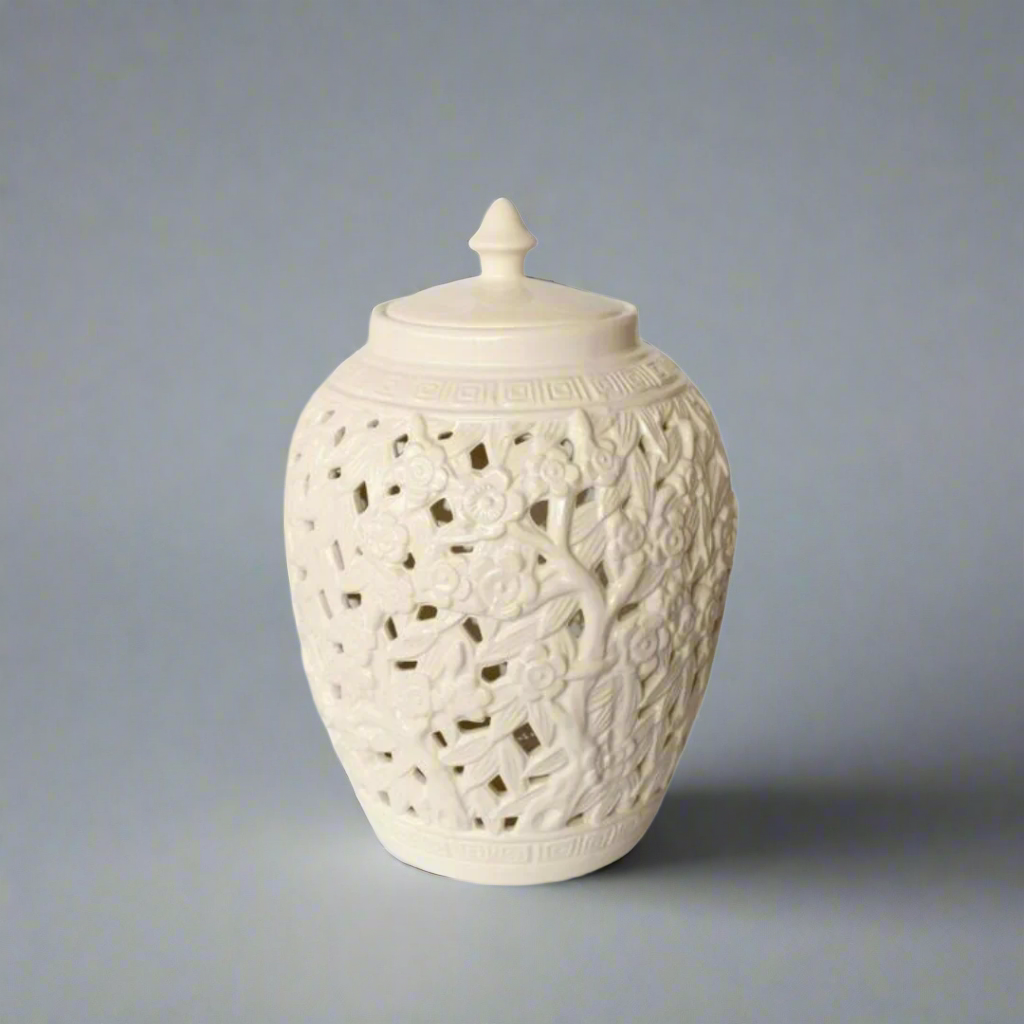 Elegant Conversation Starter: White Flower &amp; Leaf Cut-Out Jar with Lid
Elevate your home decor with the stunning White Flower &amp; Leaf Cut-Out Design Barrel Shade Jar with Lid, a masterpiece of elegance and sophistication. Measuring 40x27cm, this beautifully handcrafted jar features an intricate cut-out flower and leaf design that adds a unique touch to any room. The timeless white finish and matching lid make it a perfect fit for various decor styles. Unique Boys.