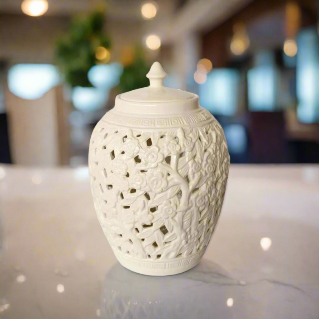 Elegant Conversation Starter: White Flower &amp; Leaf Cut-Out Jar with Lid
Elevate your home decor with the stunning White Flower &amp; Leaf Cut-Out Design Barrel Shade Jar with Lid, a masterpiece of elegance and sophistication. Measuring 40x27cm, this beautifully handcrafted jar features an intricate cut-out flower and leaf design that adds a unique touch to any room. The timeless white finish and matching lid make it a perfect fit for various decor styles.www.uniqueboys.co.za