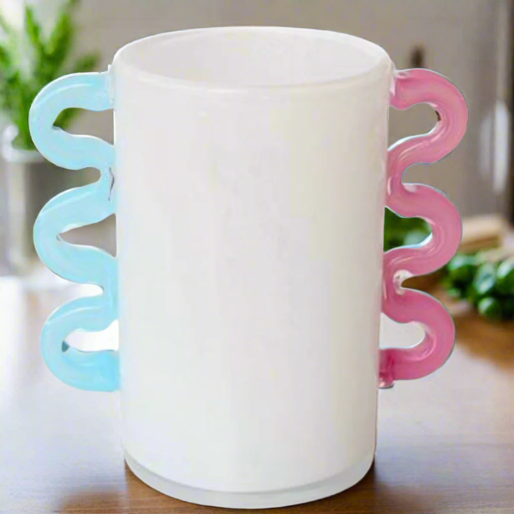 White Frosted Glass Vase with Pink &amp; Aqua Blue Handles
Add a touch of elegance to your home decor with this beautiful White Frosted Glass Vase, featuring delicate pink and aqua blue handles. Perfect for displaying flowers or as a standalone decorative piece.Unique Boys.