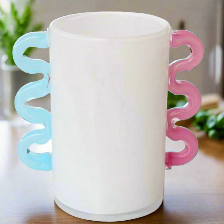 White Frosted Glass Vase with Pink &amp; Aqua Blue Handles
Add a touch of elegance to your home decor with this beautiful White Frosted Glass Vase, featuring delicate pink and aqua blue handles. Perfect for displaying flowers or as a standalone decorative piece.Unique Boys.