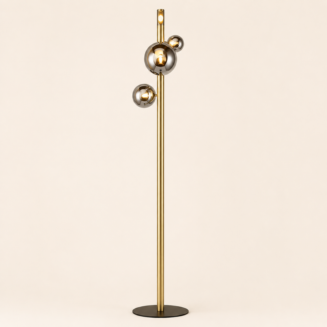 Add contemporary elegance with the Yoyo Floor Lamp, featuring a sleek gold stem and reflective globe details.