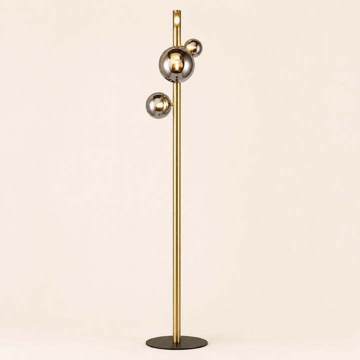 Add contemporary elegance with the Yoyo Floor Lamp, featuring a sleek gold stem and reflective globe details.