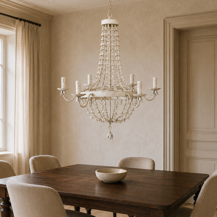 Antique white metal petal six-light chandelier styled above a dark walnut dining table