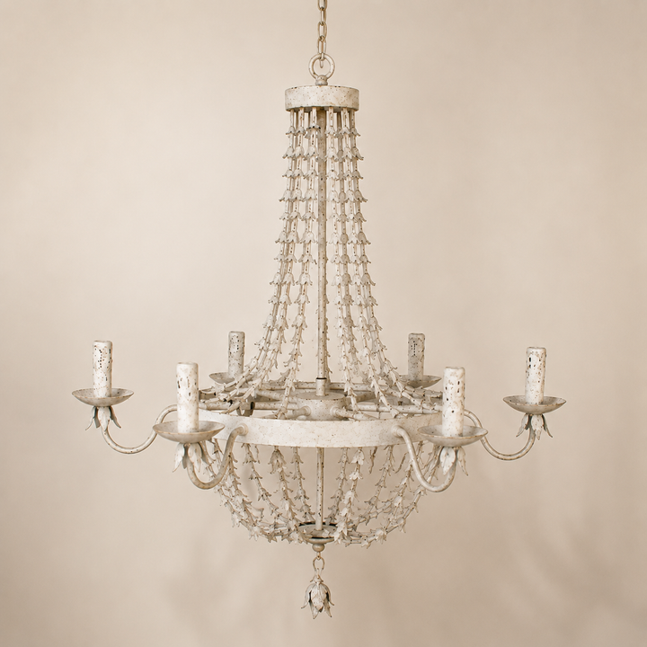 Antique white distressed metal petal six-light chandelier on a warm ivory background