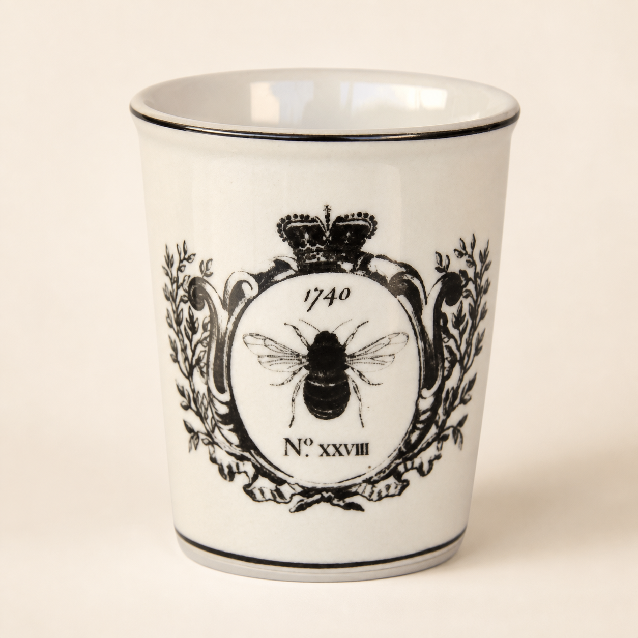 Black and white bee beaker on a warm ivory catalogue background