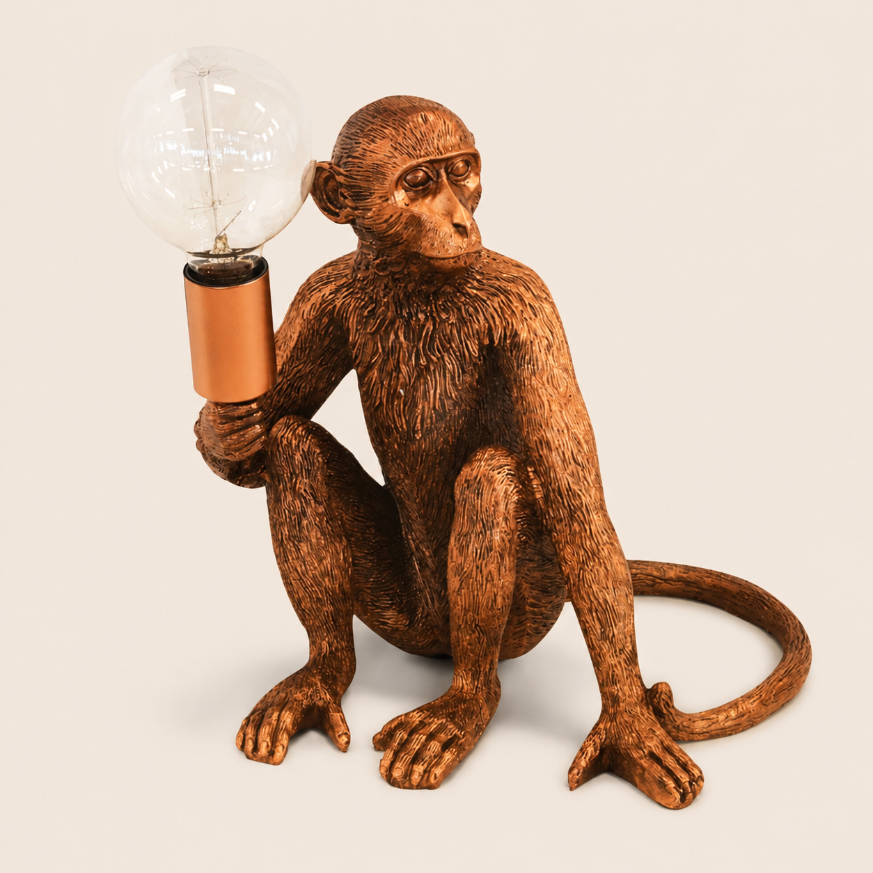 Copper monkey torch table lamp on warm beige background